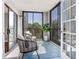 Relaxing outdoor balcony furnished with stylish seating and views of lush greenery at 14820 Rue De Bayonne # 208, Clearwater, FL 33762