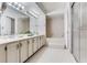 Bathroom features a large vanity, sink, mirror, and tub-shower combo at 14820 Rue De Bayonne # 208, Clearwater, FL 33762