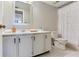 Bathroom featuring a white vanity, mirror, and a shower with a decorative shower curtain at 14820 Rue De Bayonne # 208, Clearwater, FL 33762