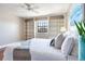 Well-lit bedroom with hardwood floors, built-in shelves, and a ceiling fan at 14820 Rue De Bayonne # 208, Clearwater, FL 33762