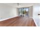 Bright bedroom with gleaming hardwood floors and sliding glass doors to a private balcony at 14820 Rue De Bayonne # 208, Clearwater, FL 33762