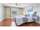 Bedroom features a queen bed, built-in bookshelves, and a ceiling fan at 14820 Rue De Bayonne # 208, Clearwater, FL 33762