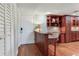 Inviting entryway with built in desk, storage, and wood floors offer an organized and stylish arrival at 14820 Rue De Bayonne # 208, Clearwater, FL 33762