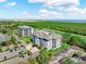Beautiful four-story condominium building with lush landscaping and convenient parking at 14820 Rue De Bayonne # 208, Clearwater, FL 33762