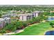 Scenic view of multi-story condominium building with beautiful golf course and pond views at 14820 Rue De Bayonne # 208, Clearwater, FL 33762