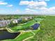Scenic aerial view of a manicured golf course and condominium buildings by the bay at 14820 Rue De Bayonne # 208, Clearwater, FL 33762