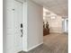 Bright hallway with chandelier lighting, decorative accents, and a door to a unit, offering a welcoming ambiance at 14820 Rue De Bayonne # 208, Clearwater, FL 33762