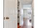 Hallway leading to a bedroom features hardwood floors and white trim at 14820 Rue De Bayonne # 208, Clearwater, FL 33762