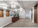 Well-lit hallway featuring elegant chandeliers, decorative vases and elevator access for convenient living at 14820 Rue De Bayonne # 208, Clearwater, FL 33762