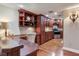 Gourmet kitchen featuring custom wood cabinetry, granite countertops, and stainless steel appliances at 14820 Rue De Bayonne # 208, Clearwater, FL 33762
