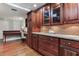 Charming kitchen featuring custom wood cabinets, granite countertops, and stainless steel appliances at 14820 Rue De Bayonne # 208, Clearwater, FL 33762