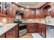 Updated kitchen with wood cabinets, stainless steel appliances, and granite countertops at 14820 Rue De Bayonne # 208, Clearwater, FL 33762