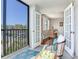 Cozy patio area featuring a wicker chair, a blue rug, and a view of the street at 14820 Rue De Bayonne # 208, Clearwater, FL 33762