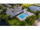Aerial of community pool with lounge seating and manicured greenery at 14820 Rue De Bayonne # 208, Clearwater, FL 33762