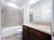 Bathroom featuring shower-tub combination with tile surround and solid surface vanity at 1723 Whitewillow Dr, Wesley Chapel, FL 33543