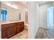Bathroom showing wood-look tile flooring, wood vanity and tiled shower at 1723 Whitewillow Dr, Wesley Chapel, FL 33543