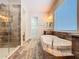 Beautiful bathroom features a soaking tub, frameless glass shower, and stylish wood-look tile flooring at 1723 Whitewillow Dr, Wesley Chapel, FL 33543