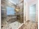 Glass-enclosed shower with tiled walls, complemented by an adjacent walk-in closet with shelving at 1723 Whitewillow Dr, Wesley Chapel, FL 33543