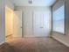 Bright bedroom with double closet, carpeted floors, and neutral paint at 1723 Whitewillow Dr, Wesley Chapel, FL 33543