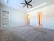 Spacious bedroom with ceiling fan and door to bathroom at 1723 Whitewillow Dr, Wesley Chapel, FL 33543