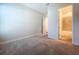 A carpeted bedroom with ensuite bathroom boasts neutral paint and natural light at 1723 Whitewillow Dr, Wesley Chapel, FL 33543