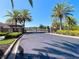 Community entrance with gate and palm trees at 1723 Whitewillow Dr, Wesley Chapel, FL 33543