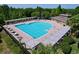 Aerial view of community pool with poolside seating and shaded areas at 1723 Whitewillow Dr, Wesley Chapel, FL 33543