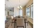 Charming dining room featuring a rectangular table, neutral-toned chairs, and a stylish chandelier at 1723 Whitewillow Dr, Wesley Chapel, FL 33543