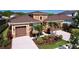 Beautiful home featuring a two-car garage and lush tropical landscaping at 1723 Whitewillow Dr, Wesley Chapel, FL 33543