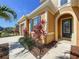Charming home featuring an arched entryway with a glass door and dark blue shutters at 1723 Whitewillow Dr, Wesley Chapel, FL 33543