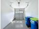 Attached garage with painted walls and sealed concrete floor, trash receptacles included at 1723 Whitewillow Dr, Wesley Chapel, FL 33543