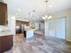 Open kitchen with island, stainless steel appliances, and sliding doors at 1723 Whitewillow Dr, Wesley Chapel, FL 33543