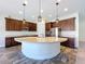 Gourmet kitchen with large island, pendant lighting, and stainless steel appliances at 1723 Whitewillow Dr, Wesley Chapel, FL 33543