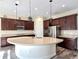 Modern kitchen featuring custom cabinetry, stainless steel appliances, and a large island at 1723 Whitewillow Dr, Wesley Chapel, FL 33543
