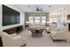 Spacious living room with a ceiling fan, carpet flooring, and ample natural light from large windows at 1723 Whitewillow Dr, Wesley Chapel, FL 33543