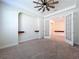Bright office space with built-in shelving, ceiling fan, and double doors at 1723 Whitewillow Dr, Wesley Chapel, FL 33543