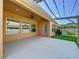 Back patio with large concrete area and partial pergola covering at 1723 Whitewillow Dr, Wesley Chapel, FL 33543