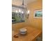 Image of dining room area with hardwood table, chandelier, and yellow accent wall at 1799 N Highland Ave # 170, Clearwater, FL 33755