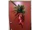 Image of the red front door with a decorative red ribboned wreath at 1799 N Highland Ave # 170, Clearwater, FL 33755