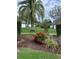 Well-maintained landscaping with palm tree, shrubs, and flowerbeds enhance the community's appeal at 1799 N Highland Ave # 170, Clearwater, FL 33755