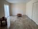 Open floor plan of living room featuring tile flooring, white walls, and a sliding glass door at 1799 N Highland Ave # 170, Clearwater, FL 33755