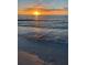 Beautiful sunset view over the water with waves gently reaching the sandy beach at 1799 N Highland Ave # 170, Clearwater, FL 33755