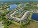 Aerial shot shows the home in a lakeside community with lush green surroundings at 19487 Roseate Dr, Lutz, FL 33558