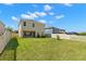 Large, fenced backyard features a well-maintained lawn, ideal for outdoor activities and relaxation at 19487 Roseate Dr, Lutz, FL 33558