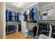 Walk-in closet with custom shelving, drawers, and ample hanging space for clothes and accessories at 19487 Roseate Dr, Lutz, FL 33558