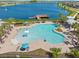 An aerial view features the community pool, dock, and lake for recreational activities at 19487 Roseate Dr, Lutz, FL 33558