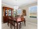 Formal dining room with wood table and chairs, chandelier, and a window with natural light at 19487 Roseate Dr, Lutz, FL 33558