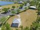 Aerial view of the community dog park, with a parking area, shelter, and lake nearby at 19487 Roseate Dr, Lutz, FL 33558