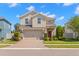 Inviting two-story home with a well-manicured lawn and a brick-paved driveway at 19487 Roseate Dr, Lutz, FL 33558