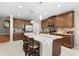 Spacious kitchen featuring granite countertops, stainless steel appliances and a large central island with barstool seating at 19487 Roseate Dr, Lutz, FL 33558